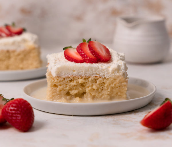 Tres Leches Cake with Sonoma Syrup Co. Vanilla and Almond Extract topped with fresh seasonal strawberries on a dish