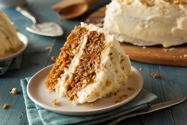 Slice of Carrot Cake with rich Cream Cheese Frosting and walnuts