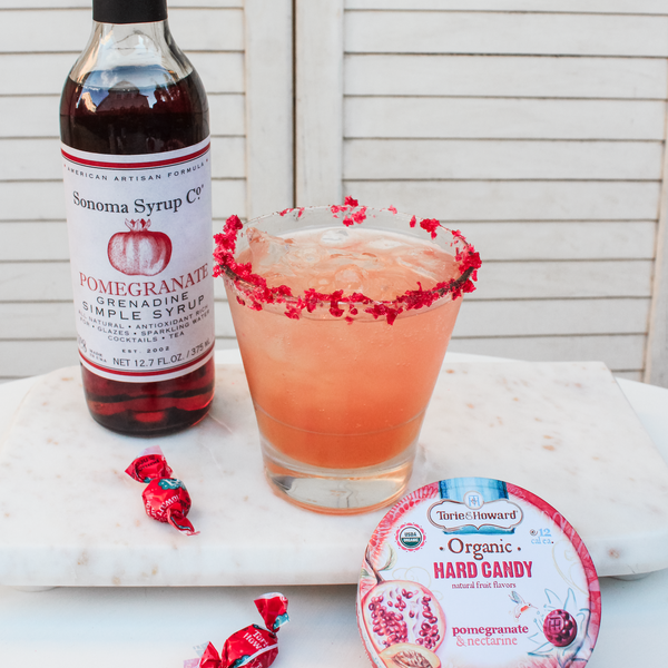 Pomegranate Paloma Cocktail with Pomegranate Simple Syrup and Crushed Hard Candy Rim