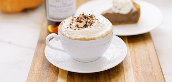 Picture of Gingerbread & Pumpkin Spice Latte topped with freshly made whipped cream and cinnamon