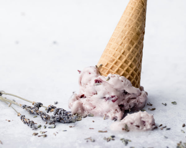 Picture of ice cream cone full of lavender lemon sorbet with fresh lavender buds