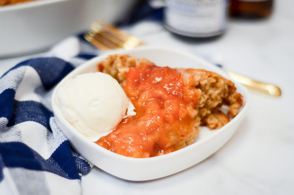 Picture of ginger peach cobbler in bowl with vanilla ice cream