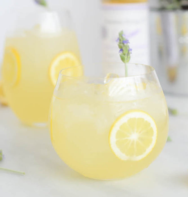 Freshly spiked lavender lemonade cocktail with a sprig of lavender