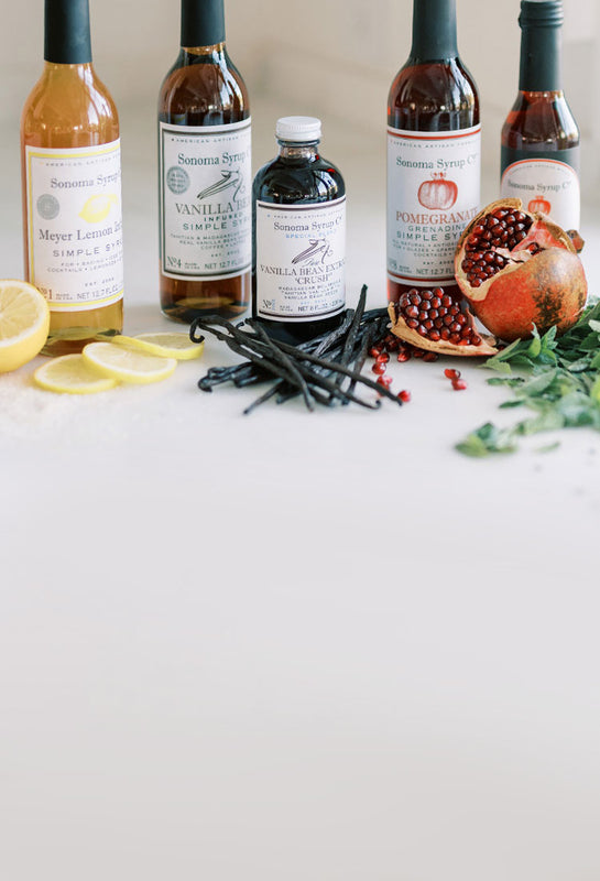 Array of Sonoma Syrup products and natural botanicals, citrus and vanilla beans