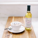 Lavender Infused Simple Syrup next to a lavender coffee latte